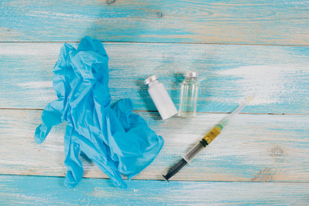 ampoules and syringe on a wooden tableの写真素材