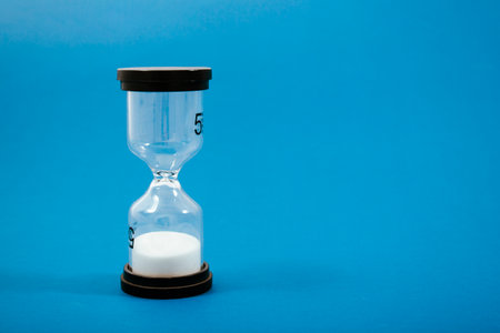 hourglass on a blue background. concept time