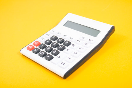calculator on an orange background. concept countingの写真素材
