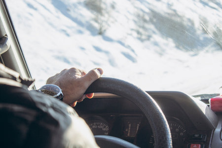 man drives a car in winterの写真素材