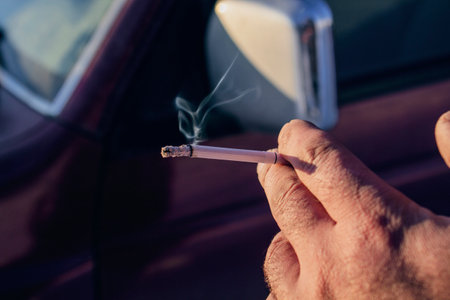 male hand holding a cigaretteの写真素材