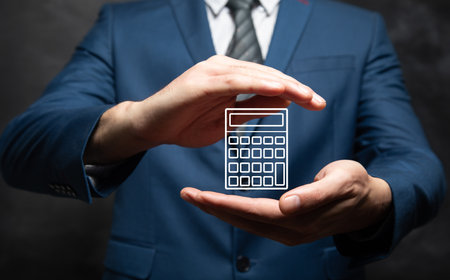 man holding a calculator icon in his handの写真素材