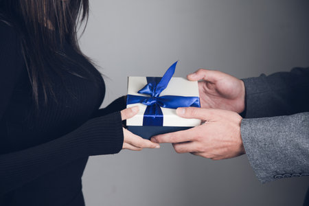 a guy gives a gift to a girlの写真素材