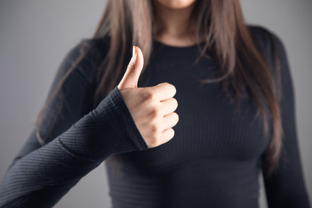 young woman showing thumbs upの写真素材