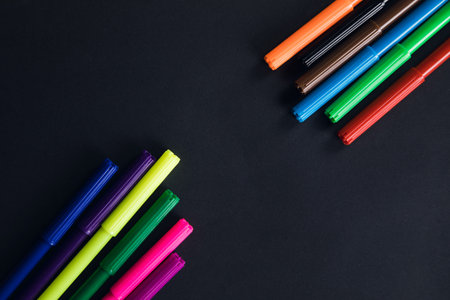 multicolored markers on a black backgroundの写真素材