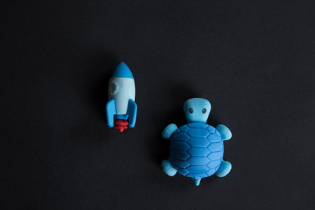 turtle and rocket compete on black backgroundの写真素材