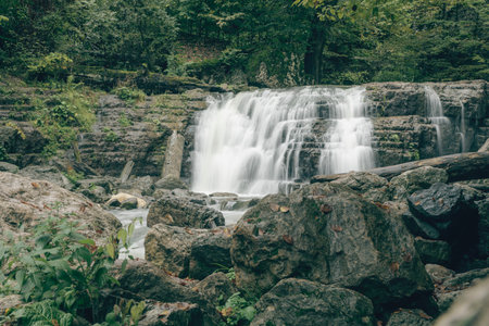 a small waterfall flows into the riverの写真素材