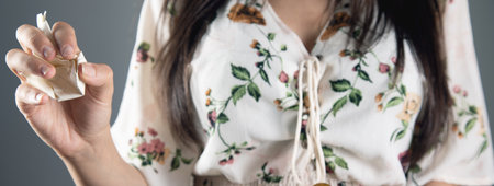 woman holding crumpled paper in her handの写真素材