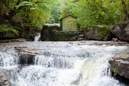 a small river in autumn and a houseの写真素材