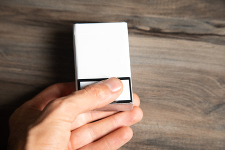 a pack of cigarettes on a wooden tableの写真素材