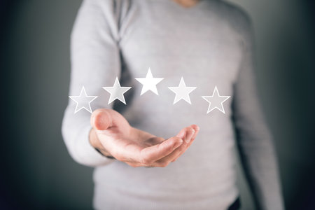 man holds stars in his hand. evaluation conceptの写真素材