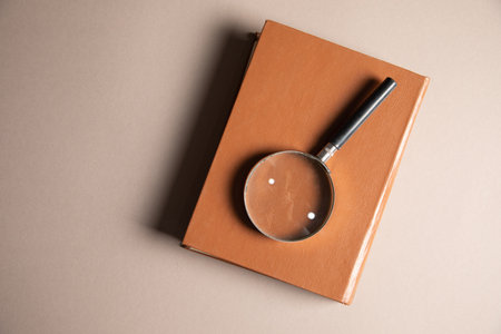 magnifier and books on the table. book study concept