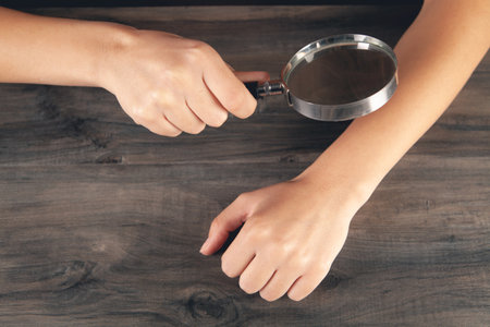 woman looking at the skin with a magnifying glass