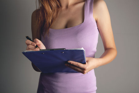 woman taking notes in paper tablet