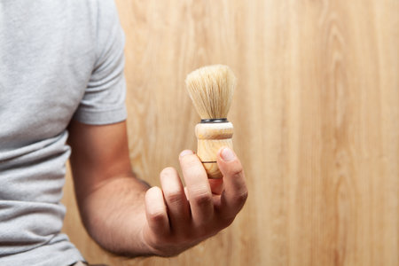 a man holding a shaving brushの写真素材