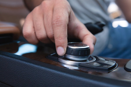 a man controls a car display with a twist