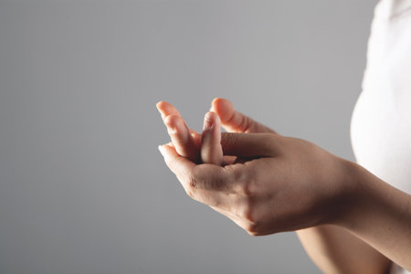 young woman has sore fingersの写真素材