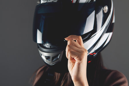 young woman standing with motorcycle helmet
