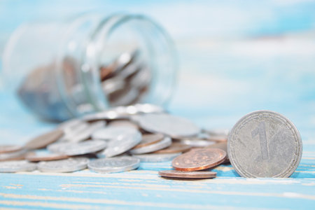 a can of coins is scattered on the table