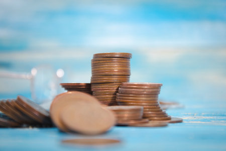 a pile of coins on the tableの写真素材