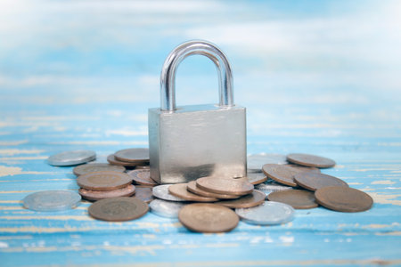 iron lock and coins on the tableの写真素材