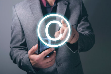 Intellectual property icon. Man clicks on the screenの写真素材