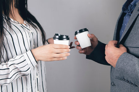 business partners are standing with a cup of coffeeの写真素材