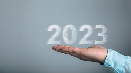2023 network on virtual screen. Man holding in his handの写真素材
