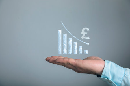Pound from the network with the chart down. The fall of the currency. Man holding in his hand