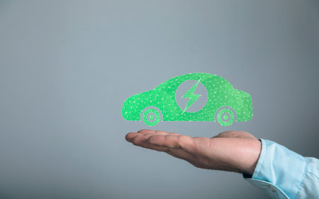 Electric car from the network. Man holding in his hand