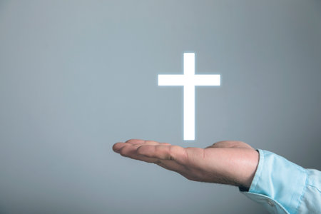 Christian cross icon. Man holding in his handの写真素材