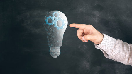 gears in a light bulb from the network. concept mechanism of ideas. Man clicks on the screenの写真素材
