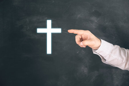 Christian cross icon. Man tapping on the screenの写真素材