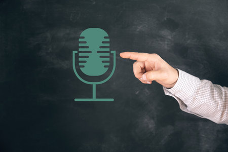 studio microphone. man tapping on the screenの写真素材