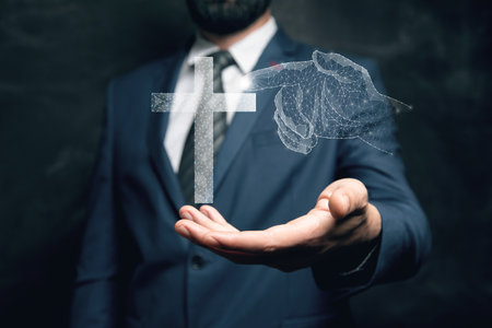 The hand clicks on the Christian cross from the web. Man holding a tablet in his handの写真素材