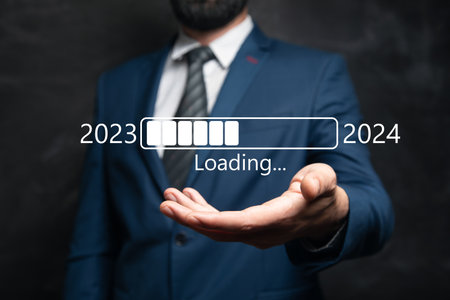 Loading from 2023 to 2024. Man holding in his handの写真素材