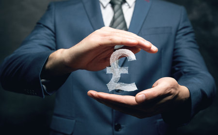 Pound sterling icon from web. Man holding in his handの写真素材