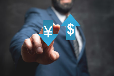 Icon of yen and dollar in arrows. Man tapping on the screenの写真素材
