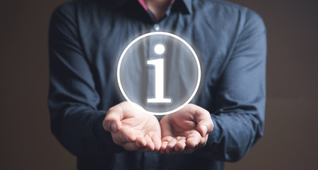 Illustrated information icon. Man holding in his handの写真素材