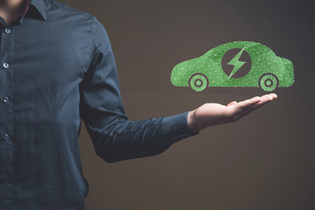 Electric car from the network. Man holding in his handの写真素材