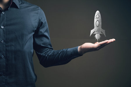 The rocket takes off from the network. Startup concept. Man holding in his handの写真素材