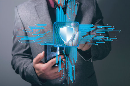 Shield on the motherboard. Cyber defense concept. Man tapping on the screen