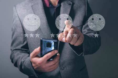 Smiley icons and quality stars from the web. Man tapping on the screenの写真素材