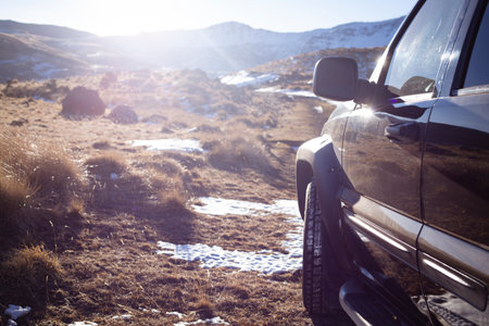 Car stands on a dirt road during the dayの写真素材