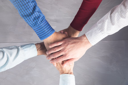 Group of people United Hands to built teamwork together with Spirit - teamwork concepts.