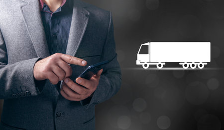 Man taps virtual screen. Truck icon on screenの写真素材