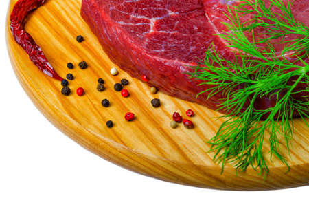Raw flank beef steak and ingredients for cooking on a wooden Board, close upの写真素材