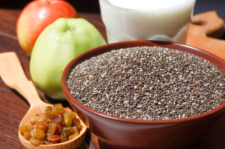 Chia in a bowl, raisins, yogurt, apples. Chia is a plant of the Lamiaceae family, a species of the genus Sage.の写真素材