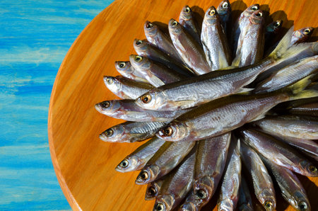Dried dried fish bleak on a wooden board. Very tasty, fatty Shemaya for beer.