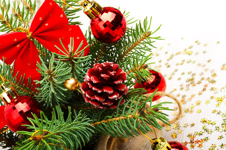 New Year card. Green pine branches, red balls, cones and bows. Place for text.の写真素材